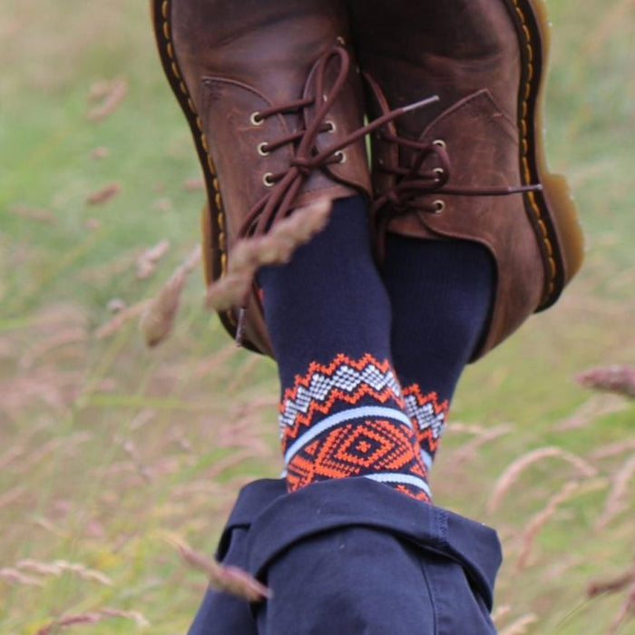 man wearing fair isle wool socks in a field 