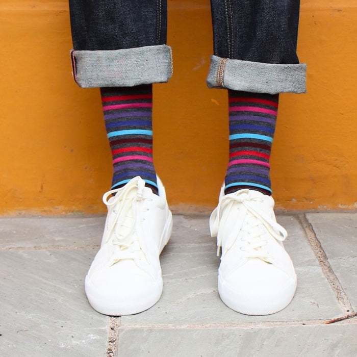 man wearing striped wool socks on a yellow background