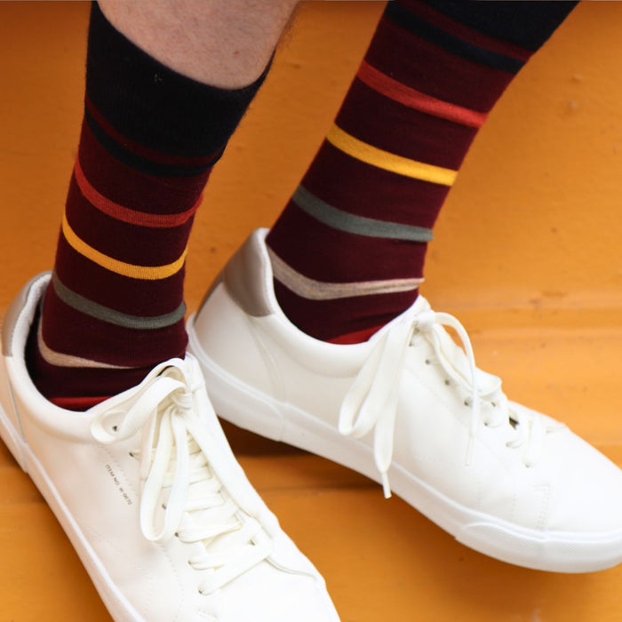 man wearing wool striped socks on a yellow background