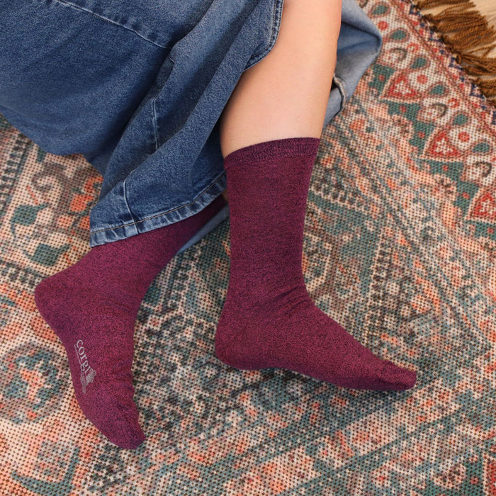 woman wearing pink melange socks on a cosy rug