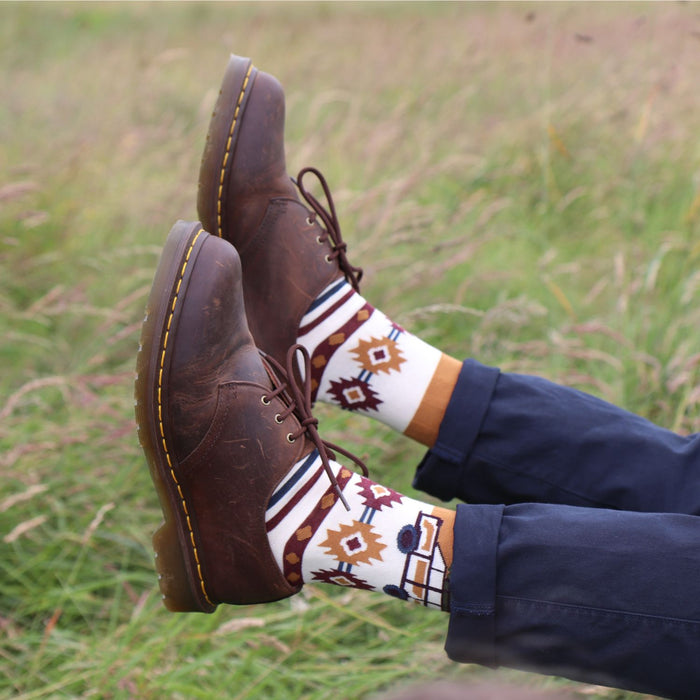 man wearing campervan cotton socks in a field