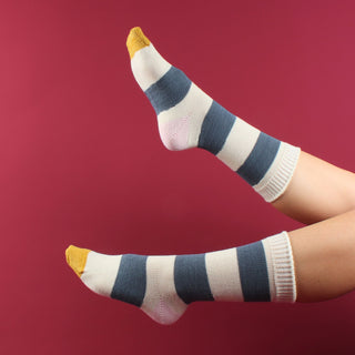 woman wearing striped wool socks on a red background