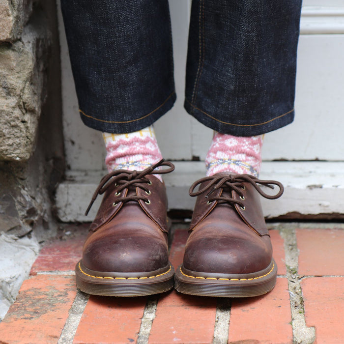 girl wearing pink fair isle wool socks and boots 